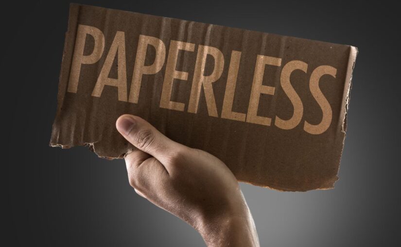 Piece of cardboard that says paperless